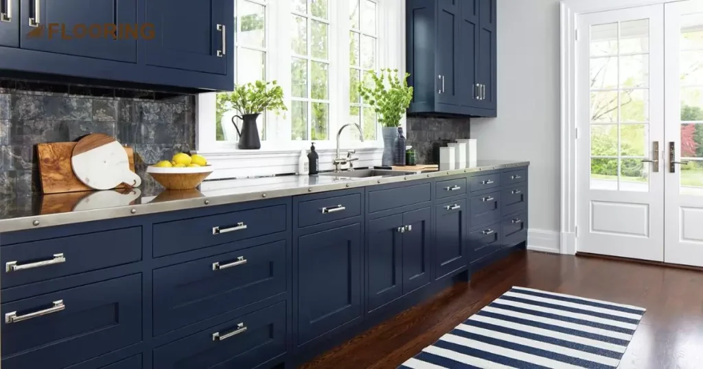 Dark Blue Cabinets with Dark Cherry Countertops and Light Natural Wood Flooring